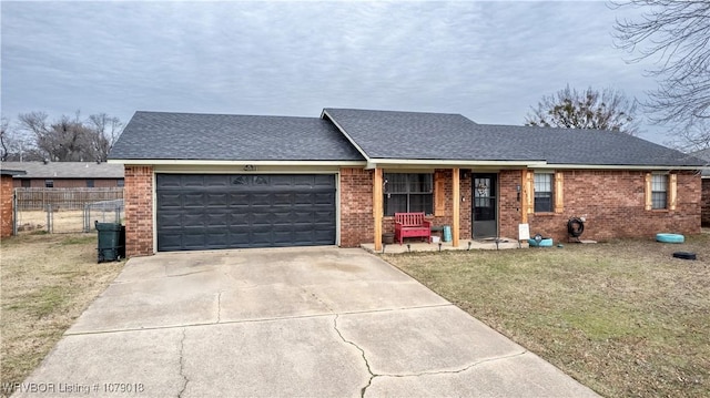 ranch-style home with a garage and a front lawn