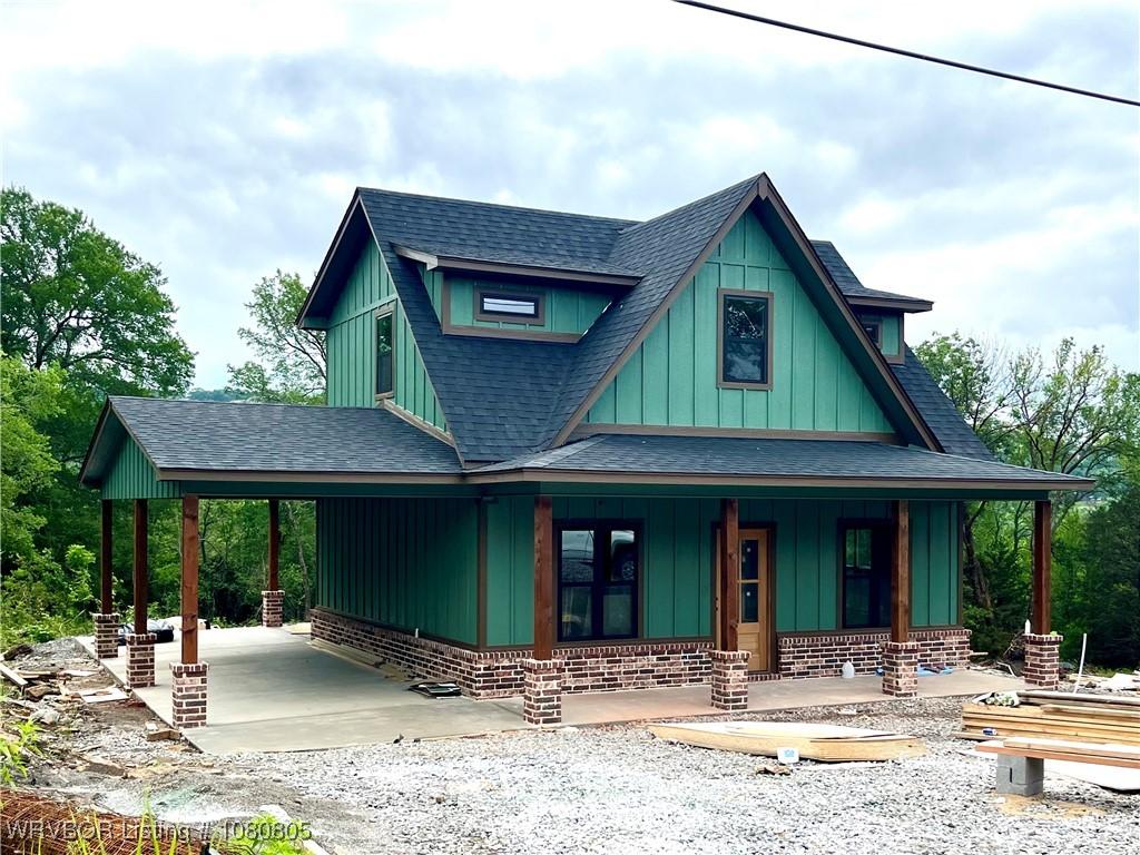 18856 W Woodhaven Dr, Cookson, OK 74427 - view of front of property with a shingled roof, covered porch, a carport, and driveway