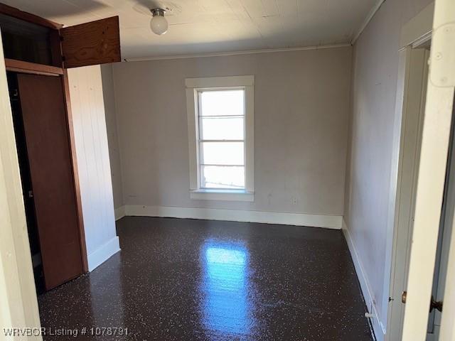 unfurnished room with crown molding