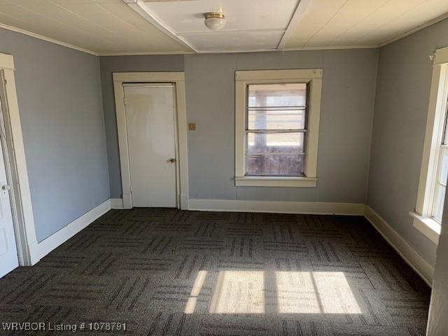 empty room featuring ornamental molding