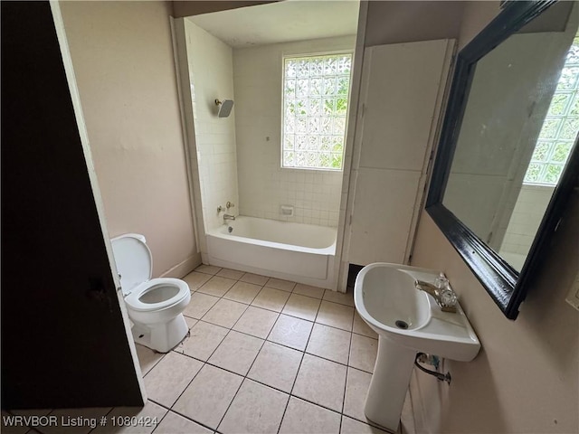 bathroom with bathtub / shower combination, a sink, tile patterned flooring, and toilet