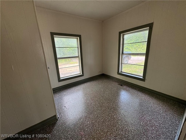 unfurnished room with crown molding, visible vents, and a healthy amount of sunlight