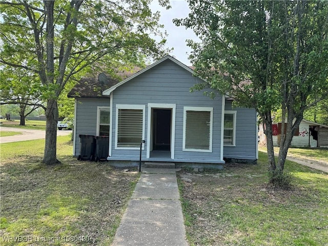 bungalow-style house with a front lawn