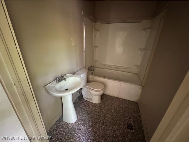 bathroom with toilet, tub / shower combination, and baseboards