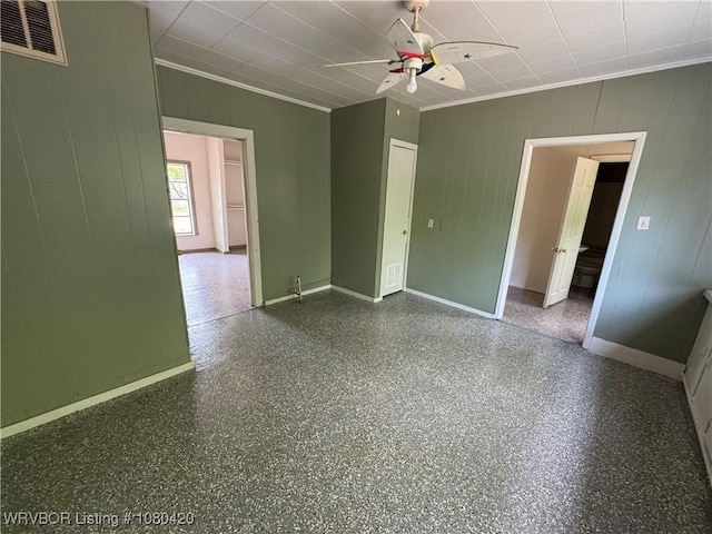 unfurnished room featuring baseboards, a ceiling fan, visible vents, and ornamental molding