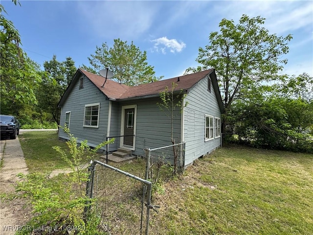 exterior space with a lawn, fence, and entry steps