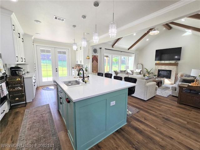 6800 Providence Way, Fort Smith, AR 72916 - kitchen with dark wood-style floors, white cabinets, a center island with sink, open floor plan, and light countertops