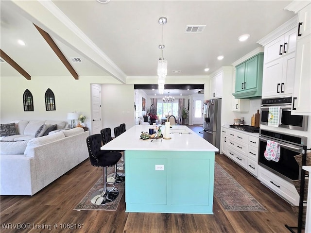 6800 Providence Way, Fort Smith, AR 72916 - kitchen with appliances with stainless steel finishes, open floor plan, a chandelier, a kitchen bar, and dark wood-type flooring