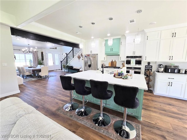 6800 Providence Way, Fort Smith, AR 72916 - kitchen featuring appliances with stainless steel finishes, open floor plan, a kitchen bar, dark wood-type flooring, and crown molding