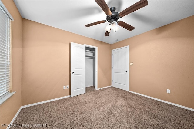 unfurnished bedroom featuring a closet, carpet, baseboards, and ceiling fan