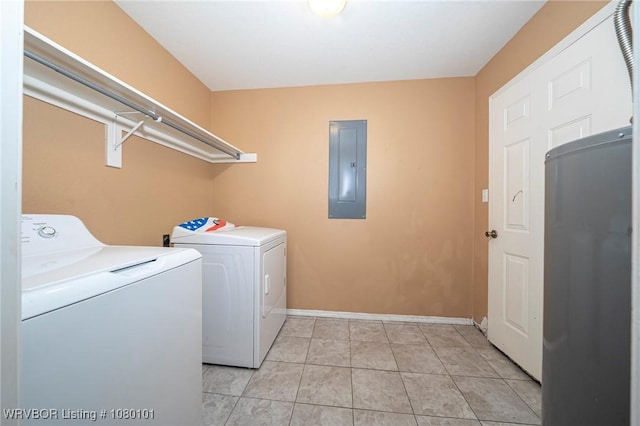 clothes washing area with laundry area, independent washer and dryer, electric panel, light tile patterned flooring, and baseboards