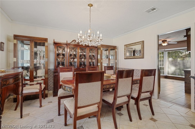 tiled dining area featuring a textured ceiling, ceiling fan with notable chandelier, and crown molding