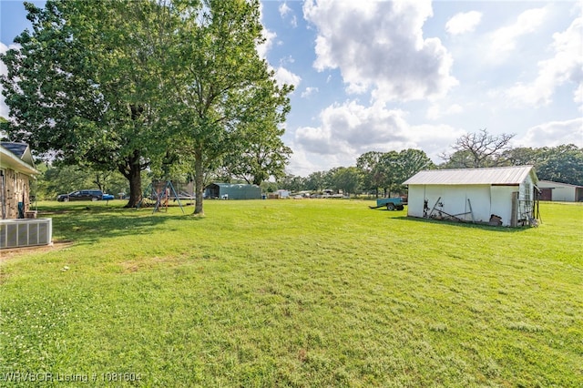 306 Dillon Cir, Pocola, OK 74902 - view of green lawn featuring central AC unit, an outdoor structure, and a pole building