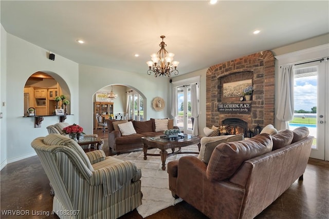 4504 Ridge Rd, Alma, AR 72921 - living area featuring a chandelier, arched walkways, a large fireplace, and recessed lighting