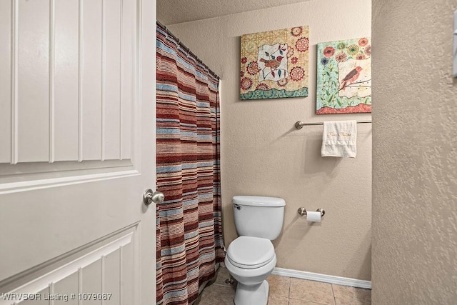 bathroom featuring tile patterned flooring, curtained shower, and toilet