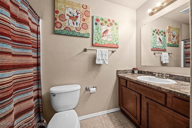 bathroom with vanity, walk in shower, toilet, and tile patterned flooring