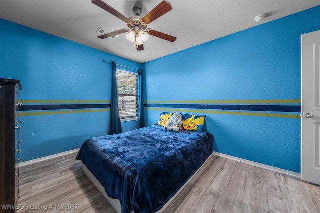 bedroom with hardwood / wood-style flooring and ceiling fan