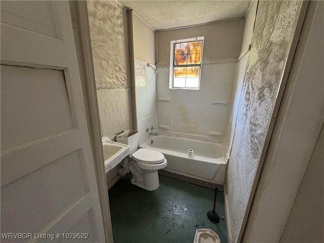 bathroom with shower / washtub combination, toilet, and a textured ceiling