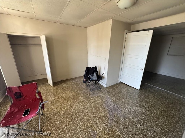 unfurnished bedroom with a drop ceiling