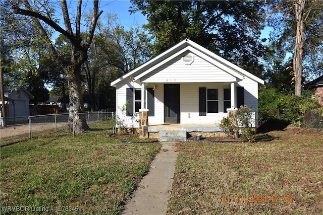 bungalow with a porch and a front yard