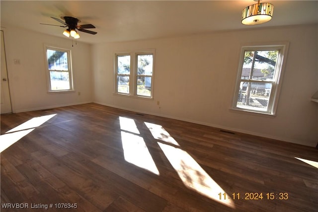 spare room featuring ceiling fan and dark hardwood / wood-style flooring