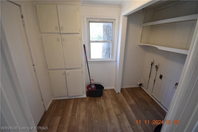 washroom featuring washer hookup, electric dryer hookup, and dark wood-type flooring