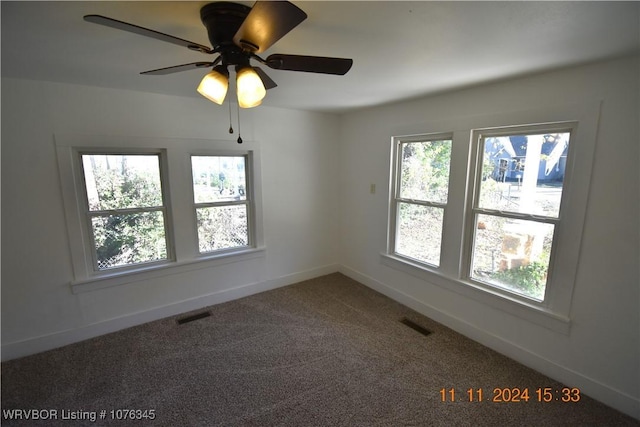 empty room with ceiling fan and carpet floors