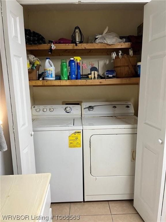 clothes washing area featuring washing machine and clothes dryer and light tile patterned floors