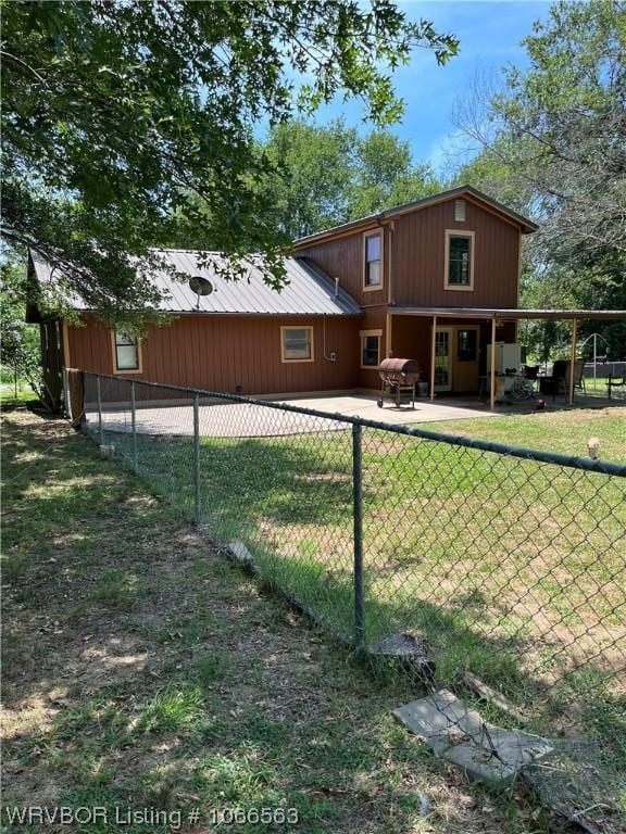 rear view of property with a patio area and a yard