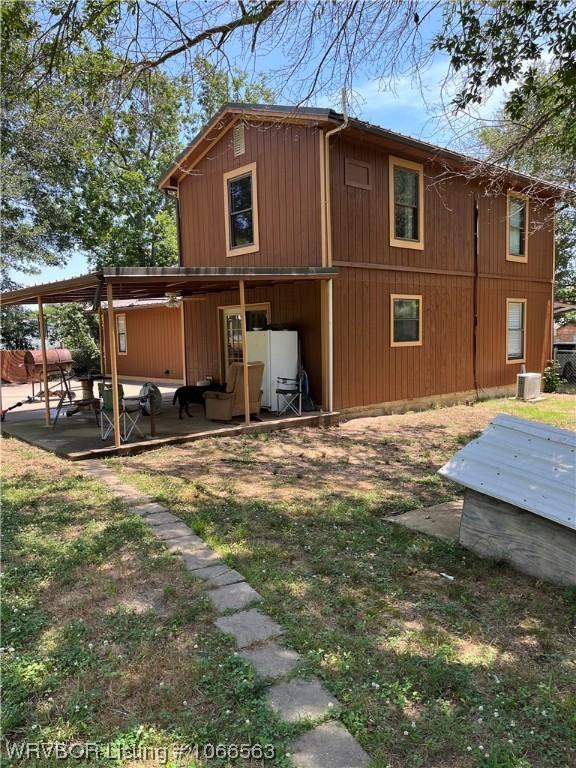 view of side of home with a patio area