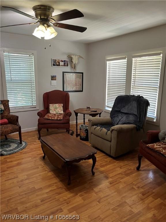 living room featuring ceiling fan, a healthy amount of sunlight, and light hardwood / wood-style flooring