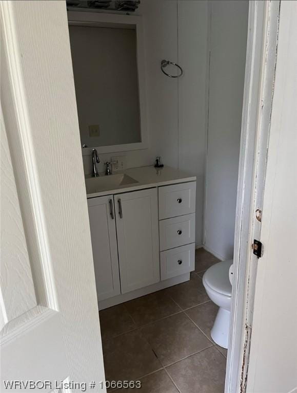 bathroom with tile patterned floors, vanity, and toilet