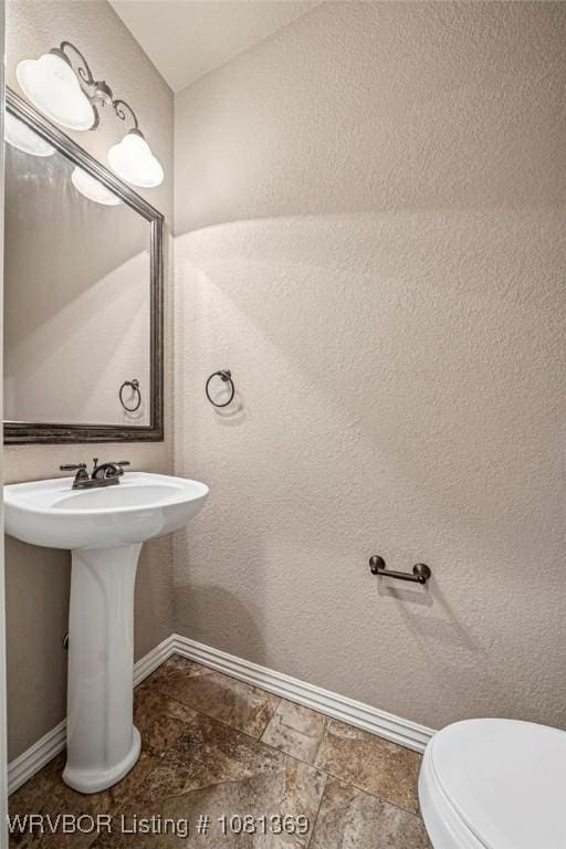 937 Forrest Park Way, Greenwood, AR 72936 - half bath with baseboards, stone finish flooring, toilet, and a sink