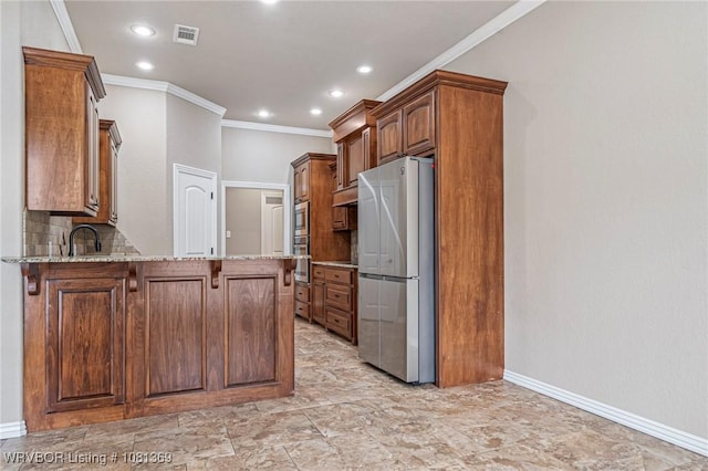 937 Forrest Park Way, Greenwood, AR 72936 - kitchen featuring stainless steel appliances, crown molding, a peninsula, light stone counters, and a kitchen bar