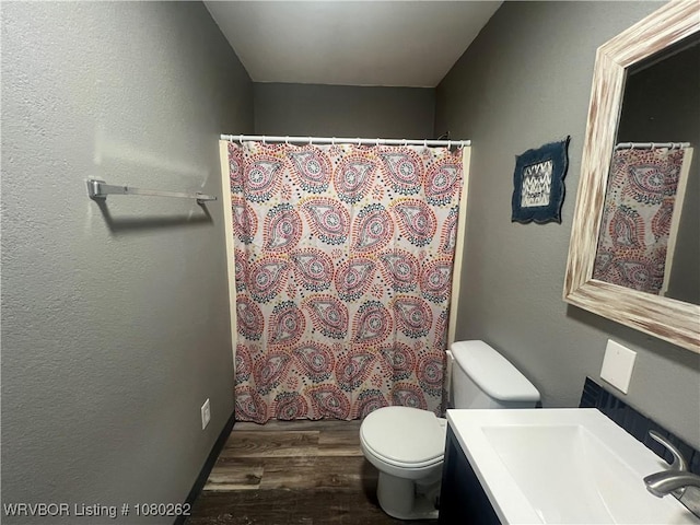 306 Dogwood, Pocola, OK 74902 - bathroom with vanity, toilet, wood finished floors, a shower with shower curtain, and a textured wall