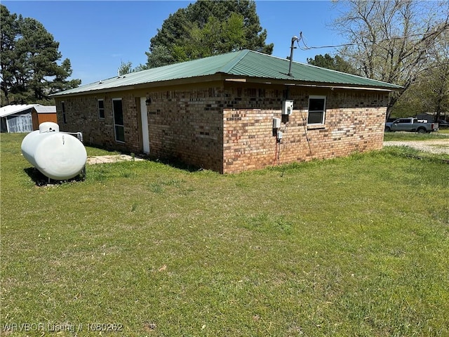 306 Dogwood, Pocola, OK 74902 - view of side of home featuring brick siding, a lawn, and metal roof