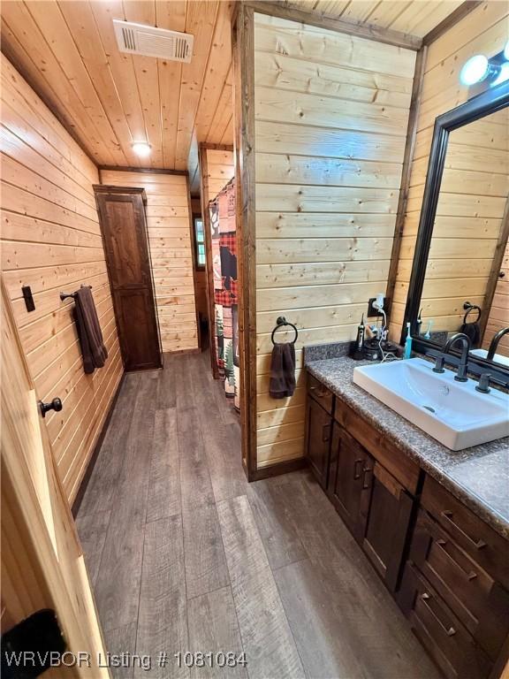 12878 128th St, Gore, OK 74435 - bathroom featuring wood walls, wooden ceiling, wood-type flooring, and vanity