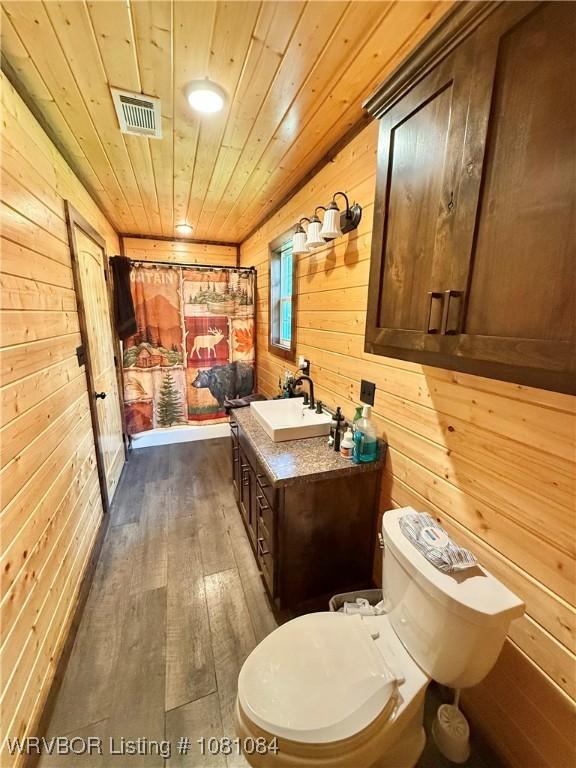 12878 128th St, Gore, OK 74435 - full bathroom with wooden walls, toilet, wood-type flooring, vanity, and wood ceiling