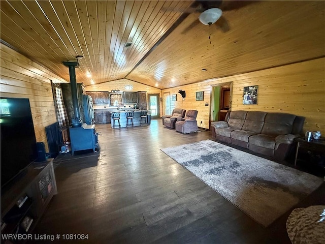 12878 128th St, Gore, OK 74435 - living room with a wood stove, vaulted ceiling, wooden walls, wood ceiling, and ceiling fan