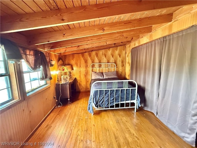 12878 128th St, Gore, OK 74435 - bedroom with hardwood / wood-style floors, wood walls, and wooden ceiling with exposed beams