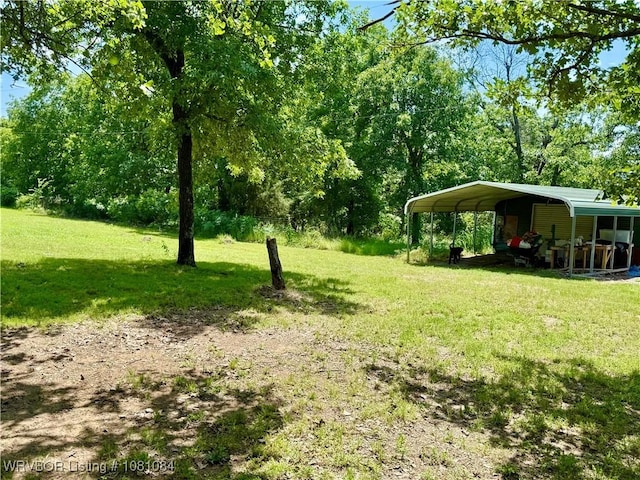12878 128th St, Gore, OK 74435 - view of green lawn with a detached carport