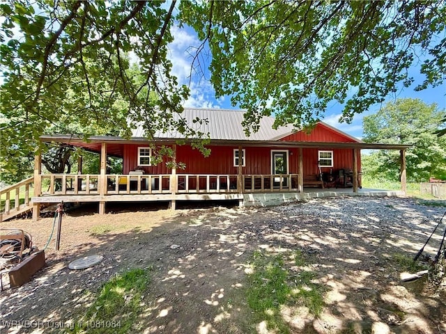 12878 128th St, Gore, OK 74435 - view of front of property with board and batten siding, a deck, and metal roof