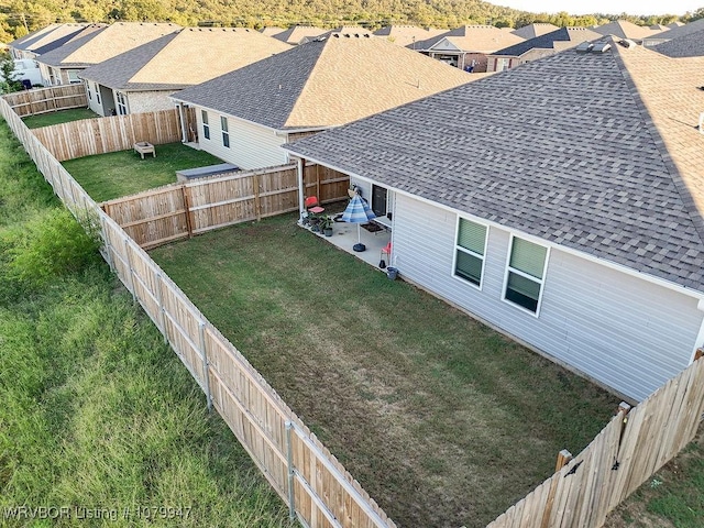 view of yard with a fenced backyard, a residential view, and a patio area
