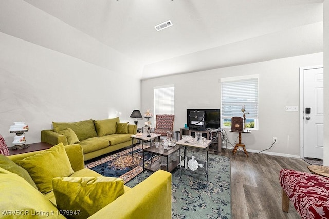 living area featuring baseboards, visible vents, wood finished floors, and plenty of natural light