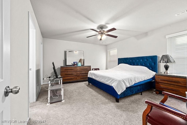 bedroom featuring visible vents, carpet flooring, and a ceiling fan