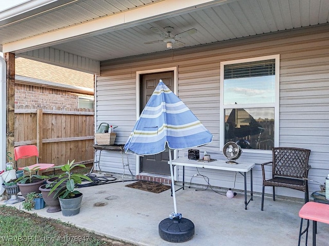 view of patio featuring fence and a ceiling fan