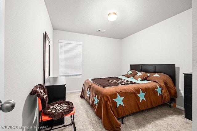 bedroom with baseboards, visible vents, carpet floors, and a textured ceiling
