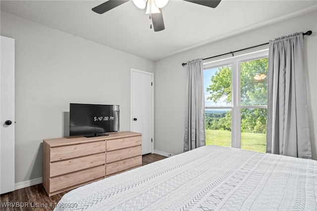 1003 Blair St, Pocola, OK 74902 - bedroom featuring baseboards, dark wood-style flooring, and a ceiling fan