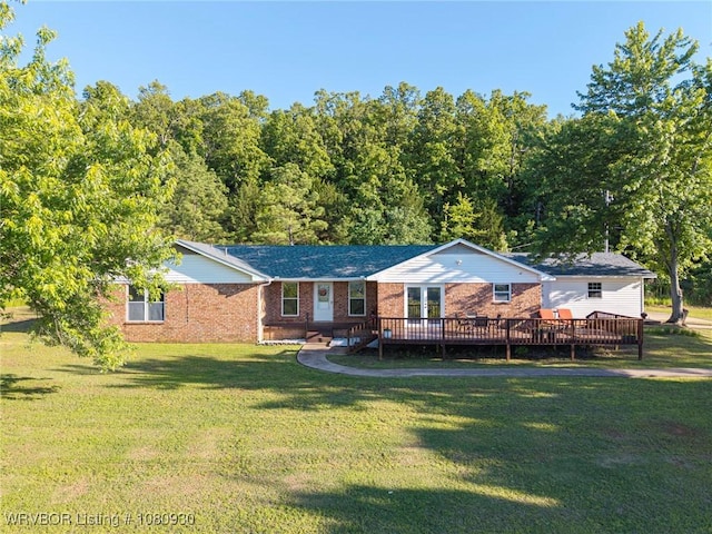 1003 Blair St, Pocola, OK 74902 - ranch-style home featuring brick siding, a front yard, a deck, and driveway
