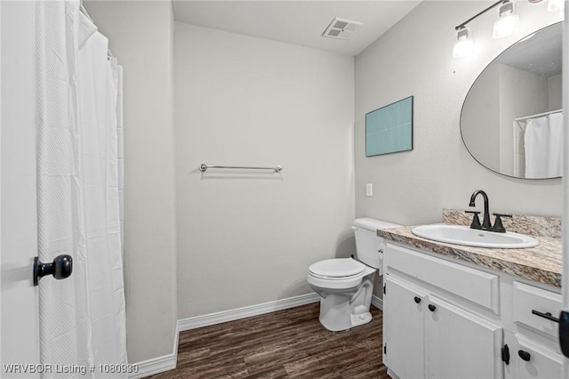 1003 Blair St, Pocola, OK 74902 - bathroom featuring wood finished floors, vanity, baseboards, and toilet
